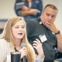 An Alumni asking a question to the panel.